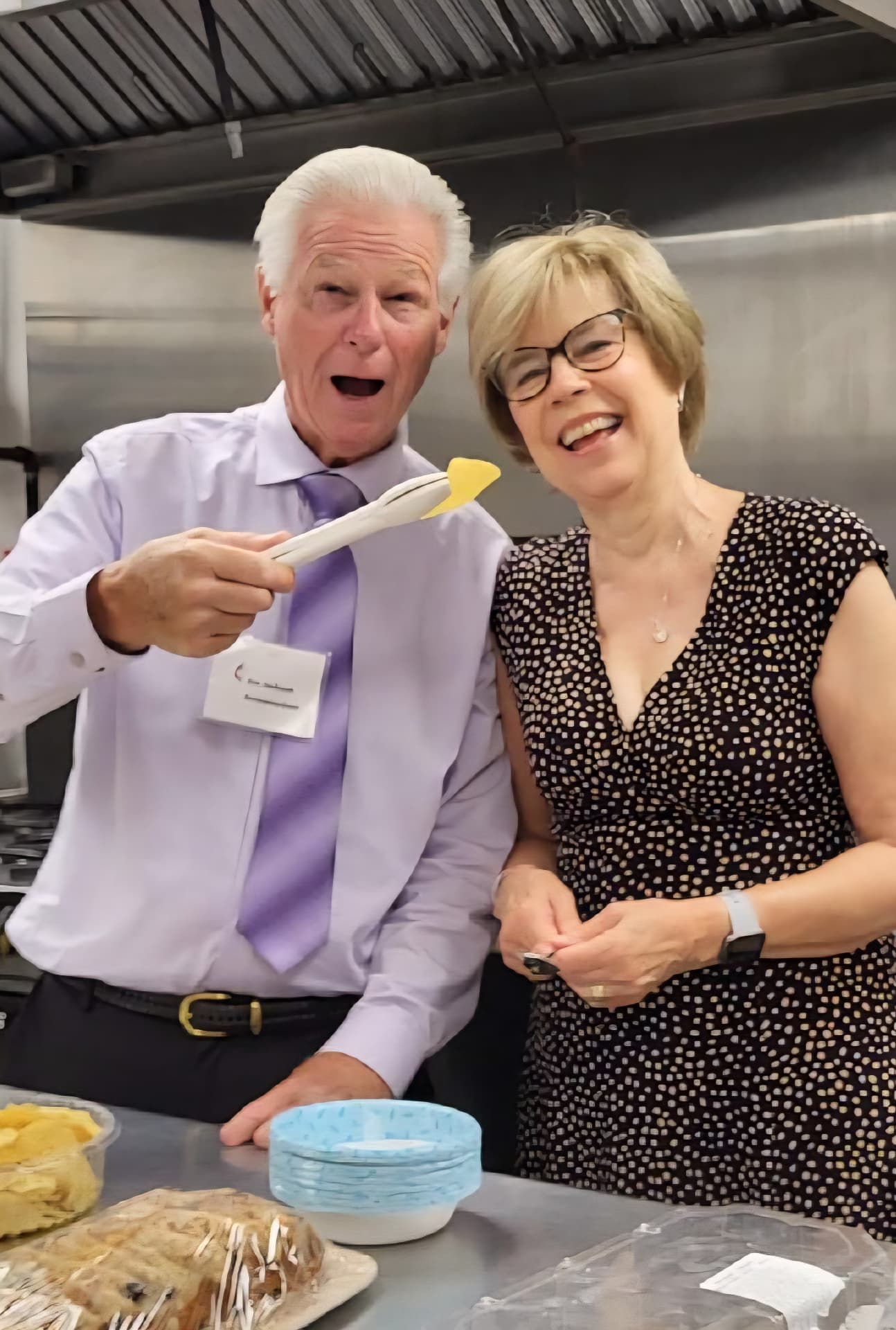 Jim and Carolyn laughing at a mission social event