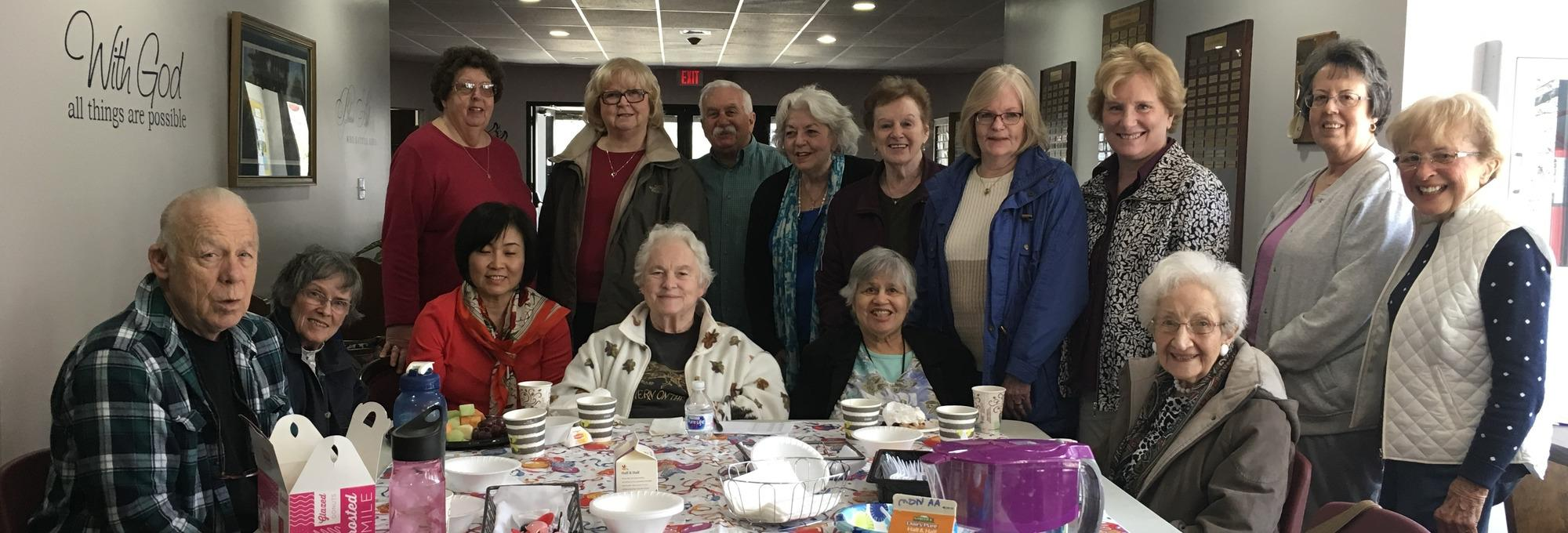Church members gathered around a table for a Something New morning