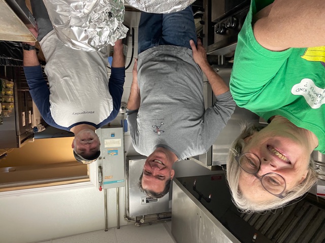 Volunteers smiling in the church kitchen